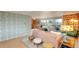 Bright living room featuring stylish, patterned wallpaper, a comfortable sofa, and access to a balcony at 1090 N Lafayette St # 504, Denver, CO 80218