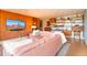 Open living room with a cozy pink sofa, wood paneling and decorative shelving at 1090 N Lafayette St # 504, Denver, CO 80218