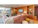 Eclectic living room featuring a cozy pink sofa, wood paneling and bright floral curtains at 1090 N Lafayette St # 504, Denver, CO 80218