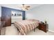 Spacious bedroom with ceiling fan and large window at 6462 E Bates Ave, Denver, CO 80222