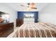 Bright bedroom with ceiling fan, dresser, and large bed at 6462 E Bates Ave, Denver, CO 80222