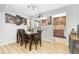 Dining room with dark wood table and chairs, kitchen view at 6462 E Bates Ave, Denver, CO 80222