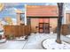 Townhouse front entrance with a walkway and snow on the ground at 6462 E Bates Ave, Denver, CO 80222