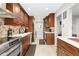 Updated kitchen with stainless steel appliances and wood cabinets at 6462 E Bates Ave, Denver, CO 80222