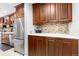 Kitchen boasts ample cabinetry and a stainless steel refrigerator at 6462 E Bates Ave, Denver, CO 80222