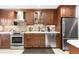 Updated kitchen with stainless steel appliances and wood cabinets at 6462 E Bates Ave, Denver, CO 80222