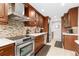 Updated kitchen with stainless steel appliances and wood cabinets at 6462 E Bates Ave, Denver, CO 80222