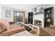 Living room with fireplace, brown couch, and sliding door to patio at 6462 E Bates Ave, Denver, CO 80222