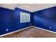 Finished basement bedroom with blue walls and wood-look flooring at 302 Linden St, Frederick, CO 80530