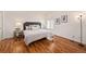 Bright bedroom with a king-size bed and hardwood floors at 302 Linden St, Frederick, CO 80530