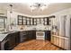 Modern kitchen with stainless steel appliances and dark cabinets at 302 Linden St, Frederick, CO 80530