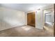 Bedroom featuring neutral carpet, a closet, and an open doorway at 8870 W Jewell Ave # 11, Lakewood, CO 80232