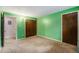 Comfortable bedroom with double closets, neutral carpet, and bright green walls at 8870 W Jewell Ave # 11, Lakewood, CO 80232