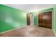 Cozy bedroom with double closets, neutral carpet, and bright green walls at 8870 W Jewell Ave # 11, Lakewood, CO 80232