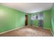 Bright bedroom with a window and carpet flooring, and a wood door at 8870 W Jewell Ave # 11, Lakewood, CO 80232