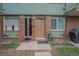 Inviting brick front entrance featuring a well maintained garden and visible address at 8870 W Jewell Ave # 11, Lakewood, CO 80232