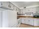 Spacious kitchen featuring white appliances and cabinets and laminate countertops at 8870 W Jewell Ave # 11, Lakewood, CO 80232