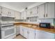 Kitchen with laminate countertops, double basin sink, and white appliances at 8870 W Jewell Ave # 11, Lakewood, CO 80232