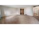 Spacious living room featuring neutral walls, plush carpeting, and a versatile layout at 8870 W Jewell Ave # 11, Lakewood, CO 80232