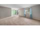 Open-concept living area with a sliding door to a balcony and view, ceiling fan, and neutral walls at 8870 W Jewell Ave # 11, Lakewood, CO 80232