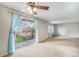 Bright open concept living area with a balcony view, ceiling fan, neutral walls and plush carpet at 8870 W Jewell Ave # 11, Lakewood, CO 80232