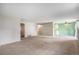 Bright and spacious living space with carpet, with a view of kitchen and neutral wall colors at 8870 W Jewell Ave # 11, Lakewood, CO 80232