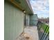 A concrete patio with a metal railing and sliding glass door at 8870 W Jewell Ave # 11, Lakewood, CO 80232
