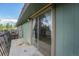 A concrete patio with a metal railing and sliding glass door at 8870 W Jewell Ave # 11, Lakewood, CO 80232