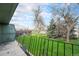 A view of a green lawn and trees from a concrete patio with railing at 8870 W Jewell Ave # 11, Lakewood, CO 80232
