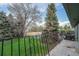 A view of a green lawn and trees from a concrete patio with railing at 8870 W Jewell Ave # 11, Lakewood, CO 80232