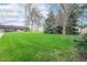 Large green lawn with mature trees at 8870 W Jewell Ave # 11, Lakewood, CO 80232