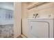 Laundry room with a washer and dryer and shelving at 14493 E Jewell Ave # 103, Aurora, CO 80012