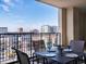 Charming outdoor dining set with city views on a sunny balcony at 975 N Lincoln St # 4F, Denver, CO 80203