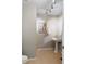 Bathroom featuring pedestal sink, decorative artwork and neutral colors at 975 N Lincoln St # 4F, Denver, CO 80203