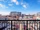 Balcony view showcasing the city skyline, street traffic, and parking area at 975 N Lincoln St # 4F, Denver, CO 80203