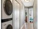 Hallway with in-unit laundry leading to rooms featuring hardwood flooring at 975 N Lincoln St # 4F, Denver, CO 80203