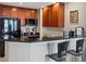 Stylish kitchen featuring black appliances, wood cabinets, and a breakfast bar with bar stools at 975 N Lincoln St # 4F, Denver, CO 80203