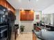 Well-lit kitchen featuring wooden cabinets, black appliances, and a functional design at 975 N Lincoln St # 4F, Denver, CO 80203