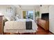 Bright main bedroom with balcony access offering city views and hardwood flooring at 975 N Lincoln St # 4F, Denver, CO 80203