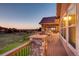 Spacious covered deck, offering stunning views and outdoor dining with stone pillars at 6963 S Espana Way, Centennial, CO 80016