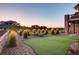Beautiful backyard featuring a putting green, fire pit area, and lush landscaping at 6963 S Espana Way, Centennial, CO 80016