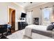 A bright bedroom with carpet flooring and a modern decor with a ceiling fan at 6963 S Espana Way, Centennial, CO 80016