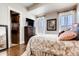 Carpeted bedroom with a beautiful bed, a chest of drawers, and lots of natural light at 6963 S Espana Way, Centennial, CO 80016