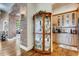 Classic butler's pantry with a china cabinet, custom cabinets, and adjacent kitchen at 6963 S Espana Way, Centennial, CO 80016