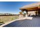 Spacious outdoor deck with stone columns, wrought iron railings, and scenic views of the surrounding landscape at 6963 S Espana Way, Centennial, CO 80016