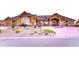 Beautiful home exterior with a circular driveway, landscaped garden beds, and well-maintained lawn at 6963 S Espana Way, Centennial, CO 80016