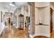 Spacious hallway with brick arches, hardwood floors, and elegant lighting at 6963 S Espana Way, Centennial, CO 80016