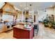 Gourmet kitchen featuring an island with granite countertops, custom cabinetry, and high-end appliances at 6963 S Espana Way, Centennial, CO 80016
