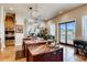 Bright kitchen with an island, modern appliances, and sliding glass doors leading to an outdoor space at 6963 S Espana Way, Centennial, CO 80016