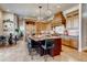 Elegant kitchen with a large central island, custom cabinets, and modern lighting fixtures at 6963 S Espana Way, Centennial, CO 80016